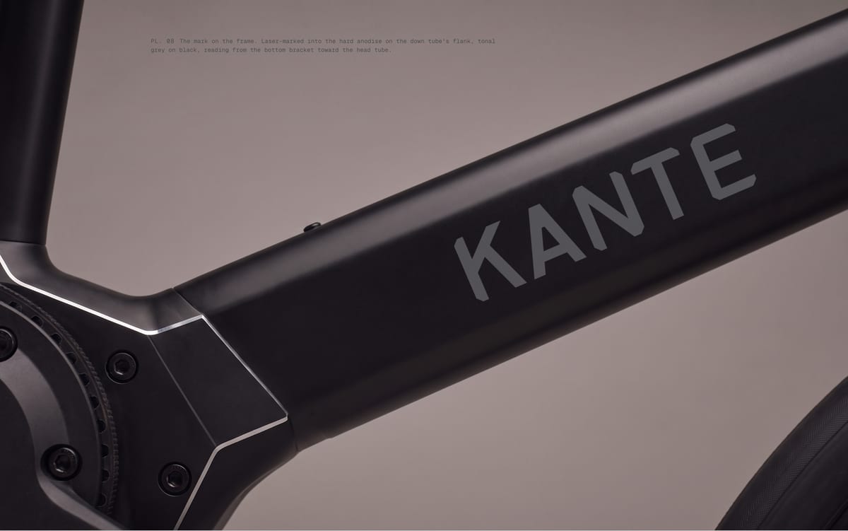 PL. 08 The mark on the frame. Laser-marked into the hard anodise on the down tube's flank, tonal grey on black, reading from the bottom bracket toward the head tube.